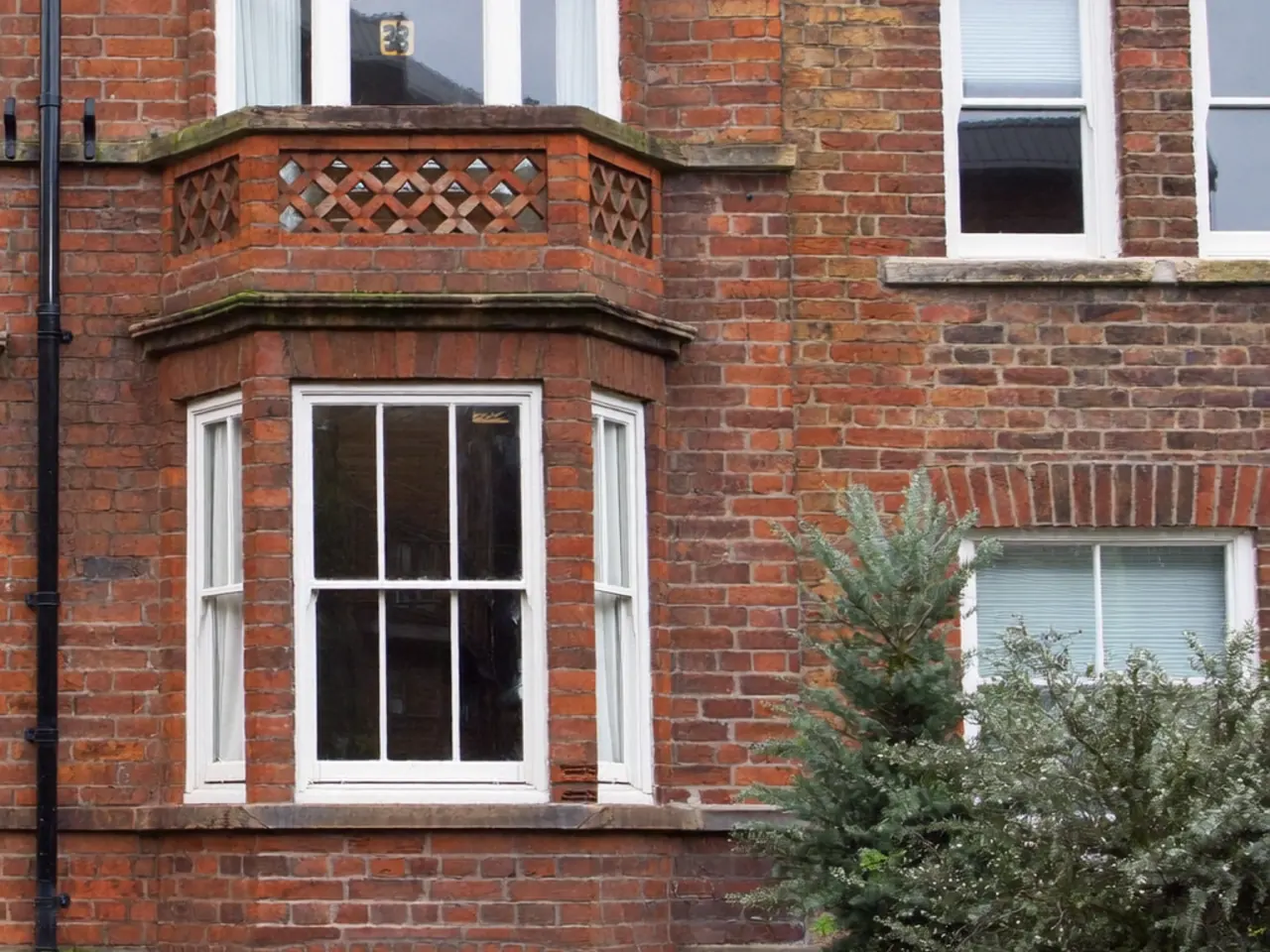 A-rated bay windows fitted to the front of a UK semi-detached brick house