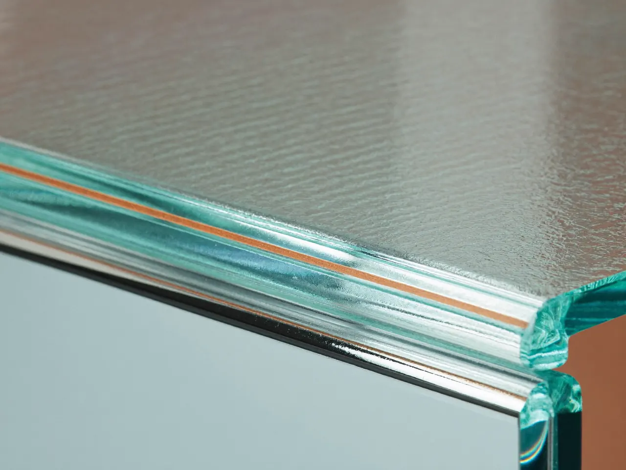 Close detail of a double-glazed sealed unit edge showing the warm-edge spacer bar