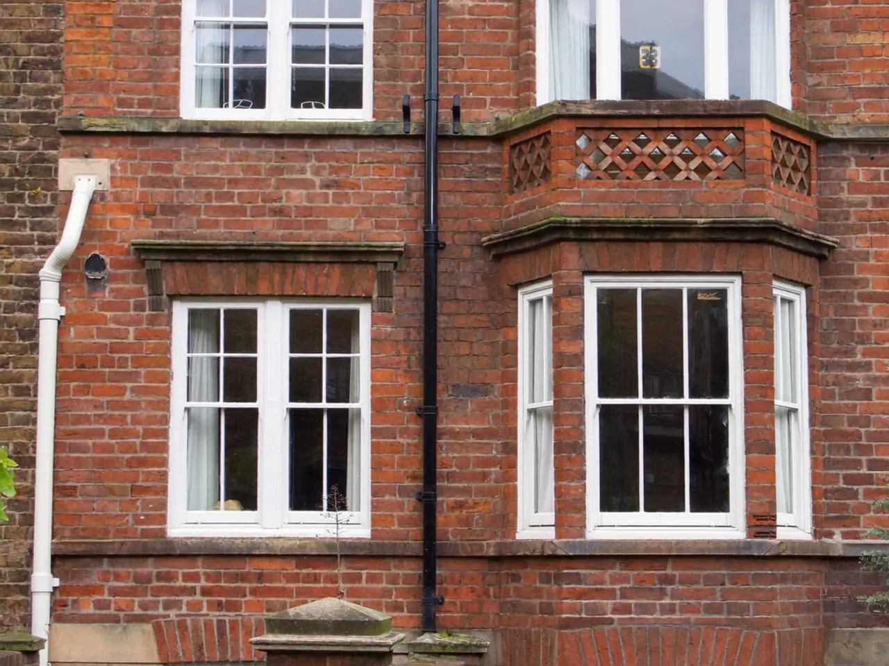 Row of period terraced houses with original timber sash windows on a UK street