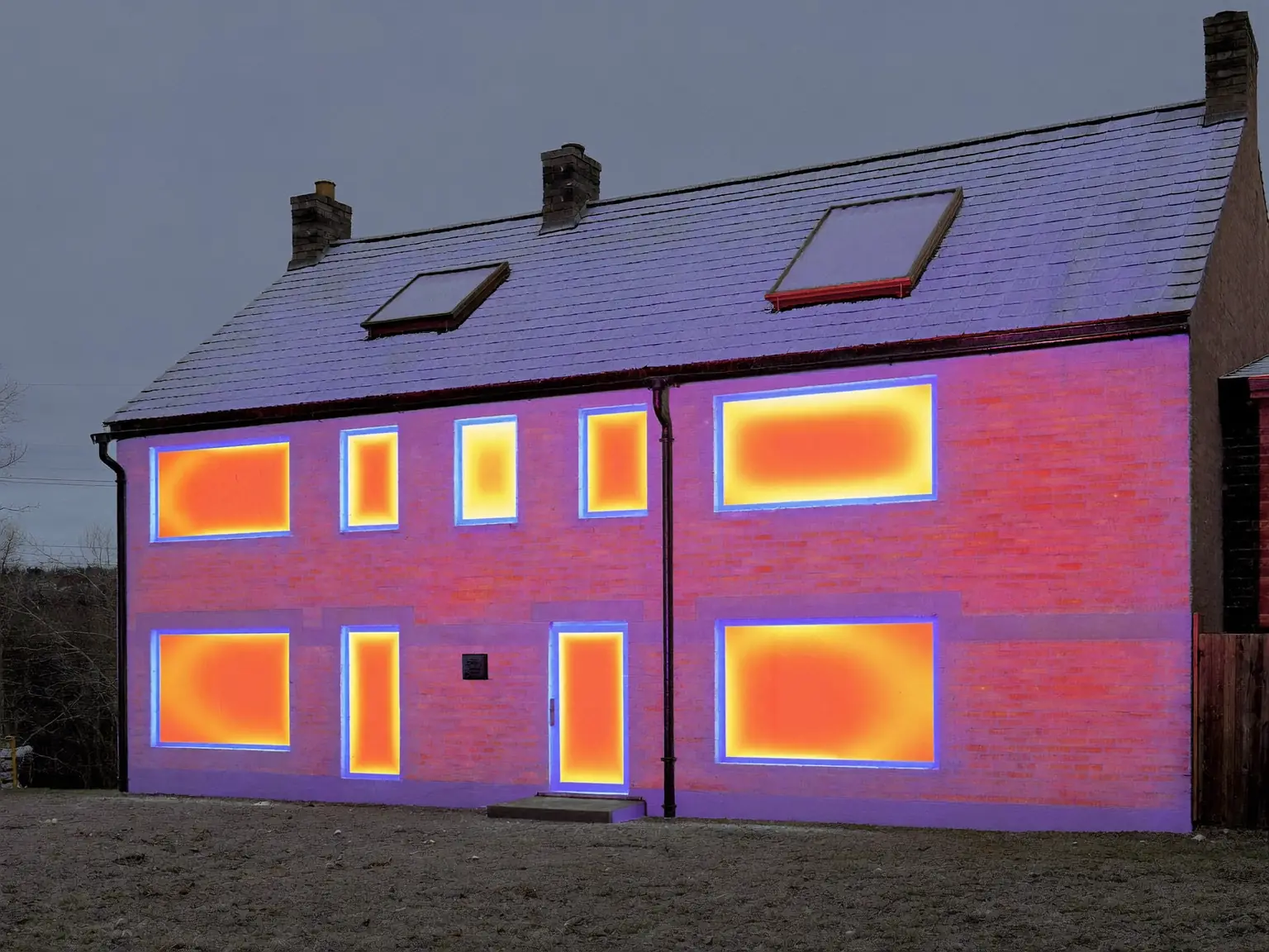 Thermal-style view of a UK house showing heat loss at the windows